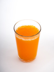 Glass of orange juice on white