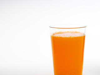 Glass of orange juice on white