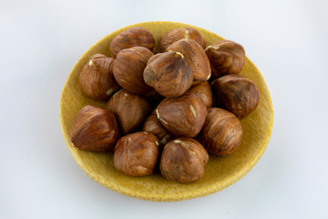 raw hazelnuts isolated on white background