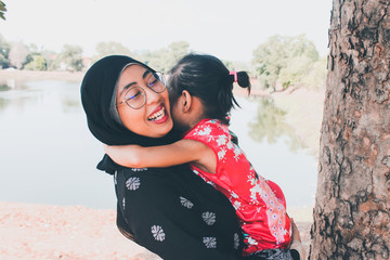 Loving mother hugging cute little daughter showing love care support, happy woman embracing girl at home, sincere warm happy relationships, Appreciating Moms concept