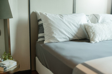 Bed maid-up with clean white pillows and bed sheets in beauty bedroom. Close-up. interior background