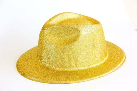 plastic fancy hat decorated in gold on white background