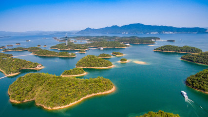 Thousand Island Lake(famous Hangzhou tourist attraction) with green mountains under blue clouds sky...