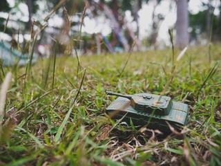 Fototapeta premium Military vehicle on the grass field