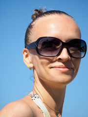 portrait young girl on vacation on the beach. background blue sky. tropical island.