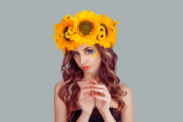 Woman with floral headband plotting something fingers hands gesture isolated on gray background....