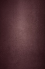 Background wall of aged textured old plaster red.