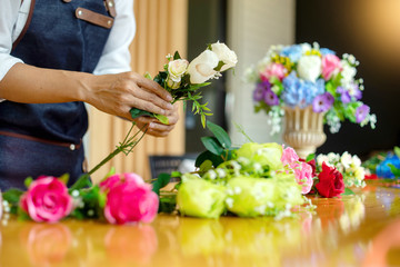 lower artist woman working to decorate  artificial flowers