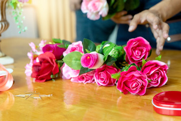 lower artist woman working to decorate  artificial flowers