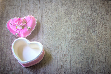 Happy Valentine's day card and open heart gift on wooden texture background
