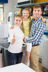 Parents with daughter in home appliance store