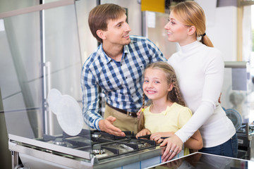 Parents with daughter in home appliance store