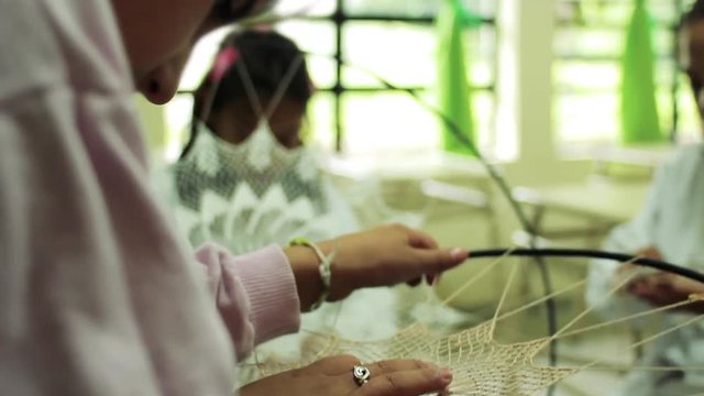 Argentine School Girl working on a Randa Handmade Lace in Art Class, The Randa is a Traditional Embroidery in Tucuman Province, Argentina. Closeup. 