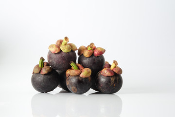 Mangosteen, an exotic asian fruit isolated on white.
