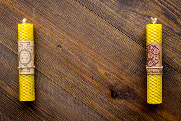 Buddhism. Candles with Yantras and mantras in sanskrit on dark wooden background top view copy space