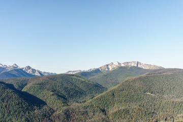 green mountain ridge scene with blue sky summer landscape background.