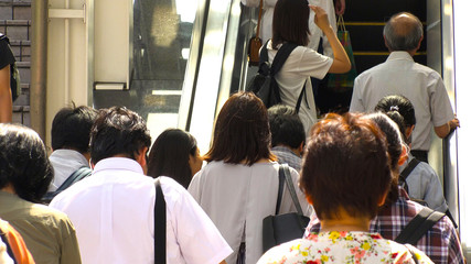 SHINJUKU,  TOKYO,  JAPAN - CIRCA MAY 2018 : BACK SHOT of PEOPLE using ESCALATOR near Shinjuku train...