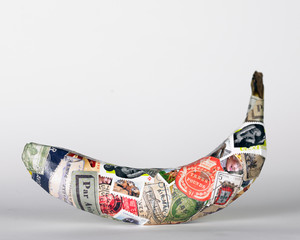 Banana covered in postal stamps