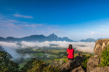 Young girl travels on high mountain in Vang-Vieng, Laos.