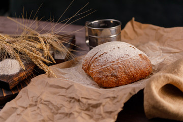 Fototapeta na wymiar Homemade rye bread and spikelets close-up. The concept of healthy food and traditional bakery.