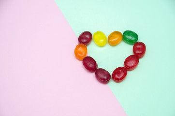 Obraz premium caramel lies in the form of a heart on the table, candy of different colors