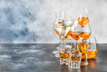 Selection of hard strong alcoholic drinks in big glasses and small shot glass in assortent: vodka,...