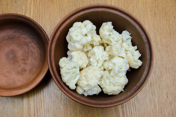 the cauliflower is in the plate, the cabbage is cut into pieces in the dish