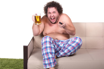 Fototapeta premium Funny fat man watching tv at home.