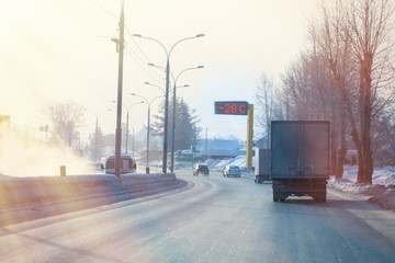 winter cold and smog on the roads, road thermometer shows sub-zero temperature