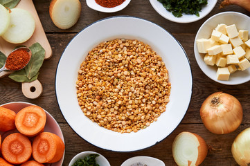 Ingredients for cooking pea porridge on a wooden background 