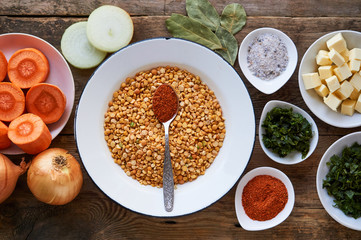 Ingredients for cooking pea porridge on a wooden background 
