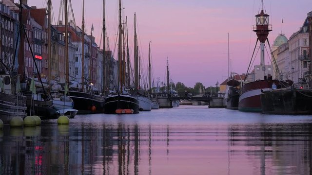 A beautiful sunset over the Nyhaven canal in Copenhagen. Filmed on a clear summer evening in one of Denmark's most iconic streets.
