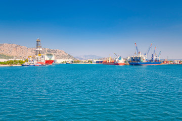 Obraz premium sea cargo port for loading container ships, on the Mediterranean coast, cranes, containers, ships