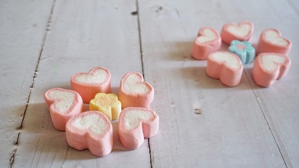 Marshmallows on wooden table.