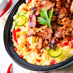 Tajin with couscous, vegetables and meat on white background