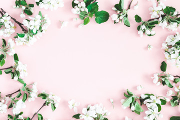 Fototapeta na wymiar Flowers composition. Apple tree flowers on pastel pink background. Spring concept. Flat lay, top view, copy space