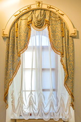 Vintage window with beautiful, elegant curtains