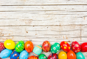 Easter background with handmade colored eggs. Top view and copy space. Festive tradition