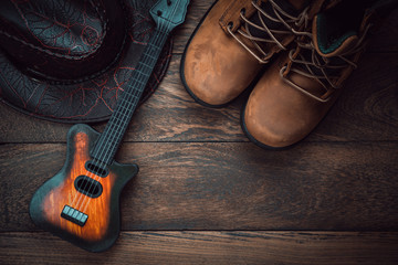 Table top view aerial image of music instruments & clothing background concept.Flat lay guitar with...