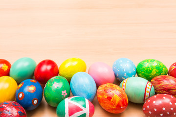 Easter background with handmade colored eggs. Top view and copy space. Festive tradition