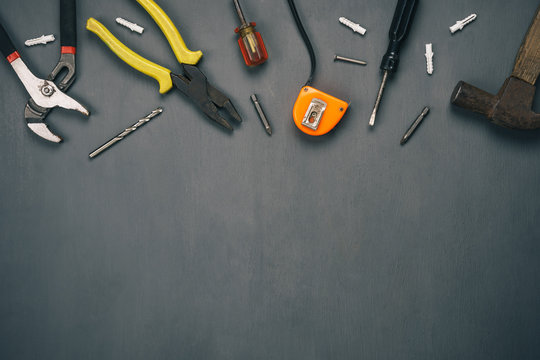 Table top view aerial image of decoration the sign of labor day or tools worker background concept.Flat lay accessories essential equipment technician on modern  rustic grey wooden with copy space.