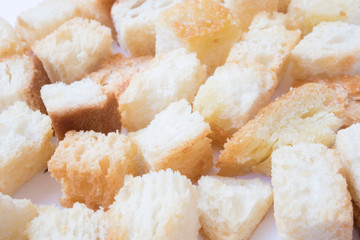 Pieces of roasted white bread . Close-up of delicious croutons.
