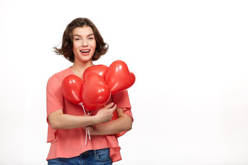 Beautiful girl holding balls in the form of a heart
