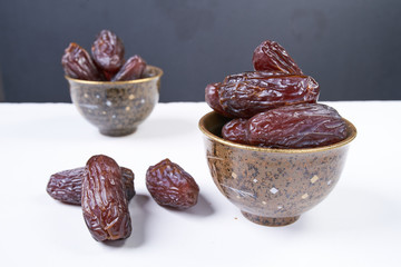 sweet dried dates fruit on white table