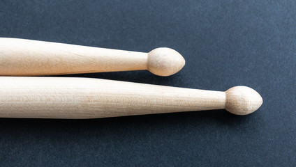 Two wooden drumsticks isolated on black background