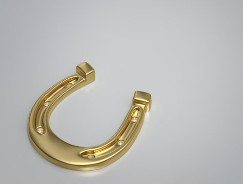 Golden horseshoe on gray background with copy space