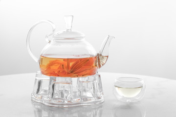 Hot flower tea in glass pot