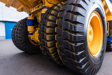 Huge wheels of a yellow dump truck