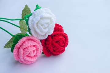 Crochet roses with yarn for giving to those we love, Valentine's day isolated on white paper background.