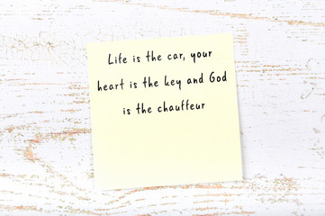 Positive inspiring quote handwritten on sticky note on wooden background